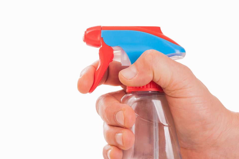 Hand with spray bottle ready for cleaning stains