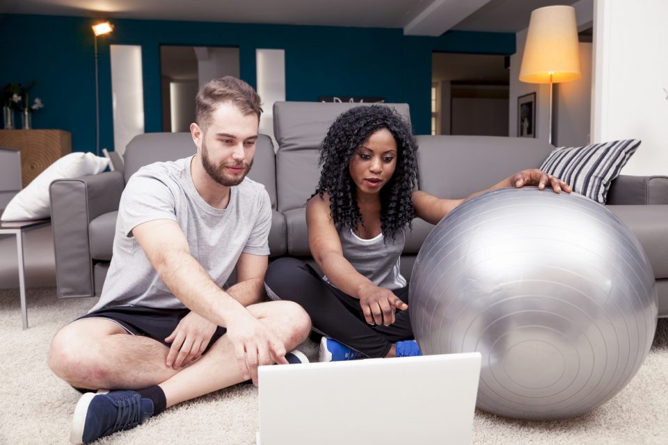 A couple prepares to workout at home.