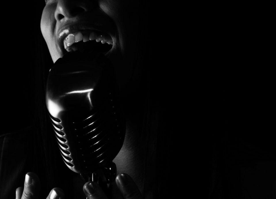 Close up of Singer singing into a microphone