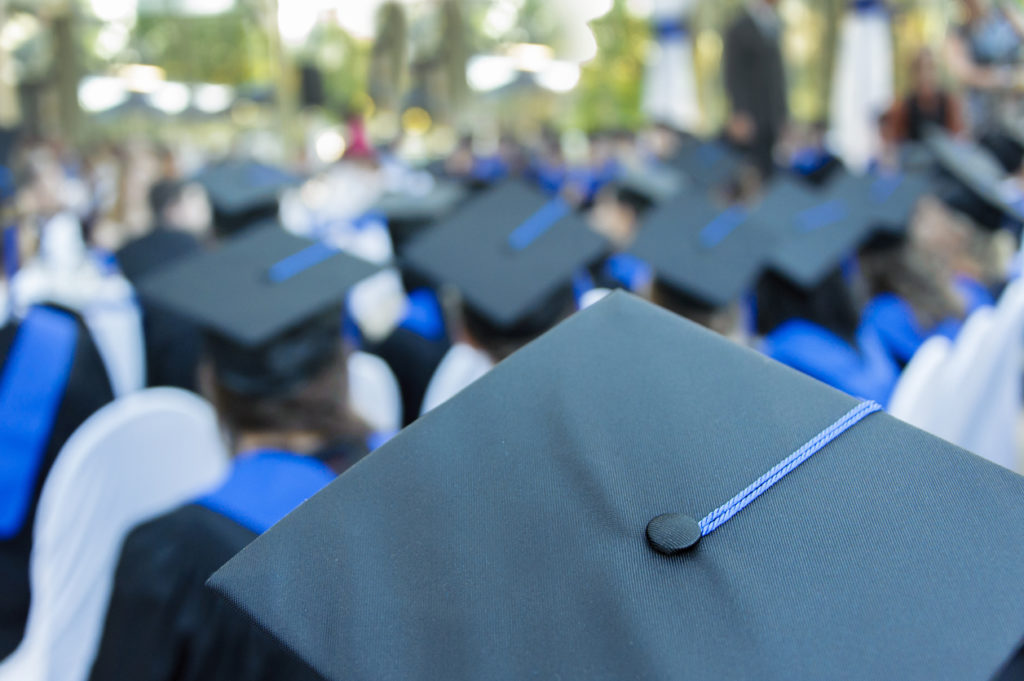 Closeup of mortarboard hats as students attend their graduation