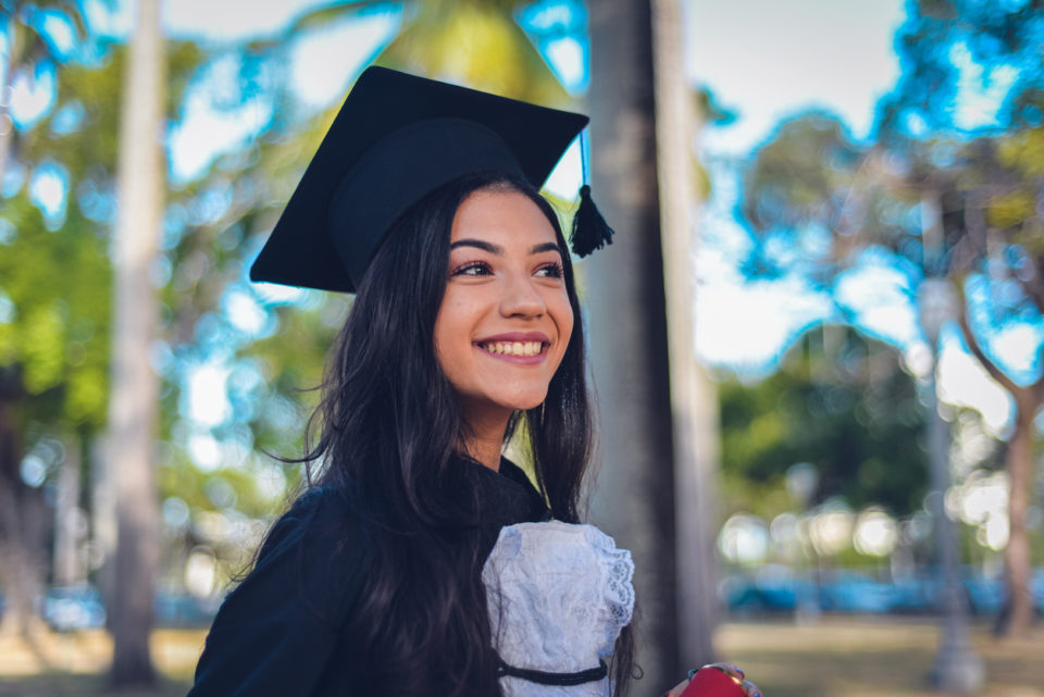 A young woman wearing a cap and gown.