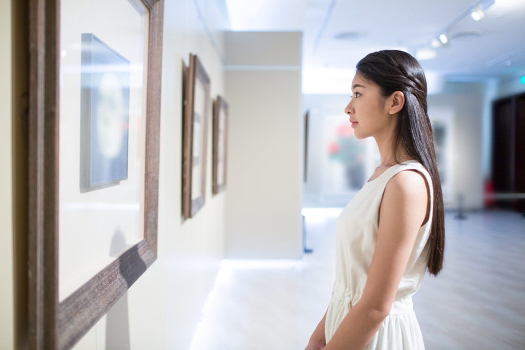 young girl looking at art in a museum