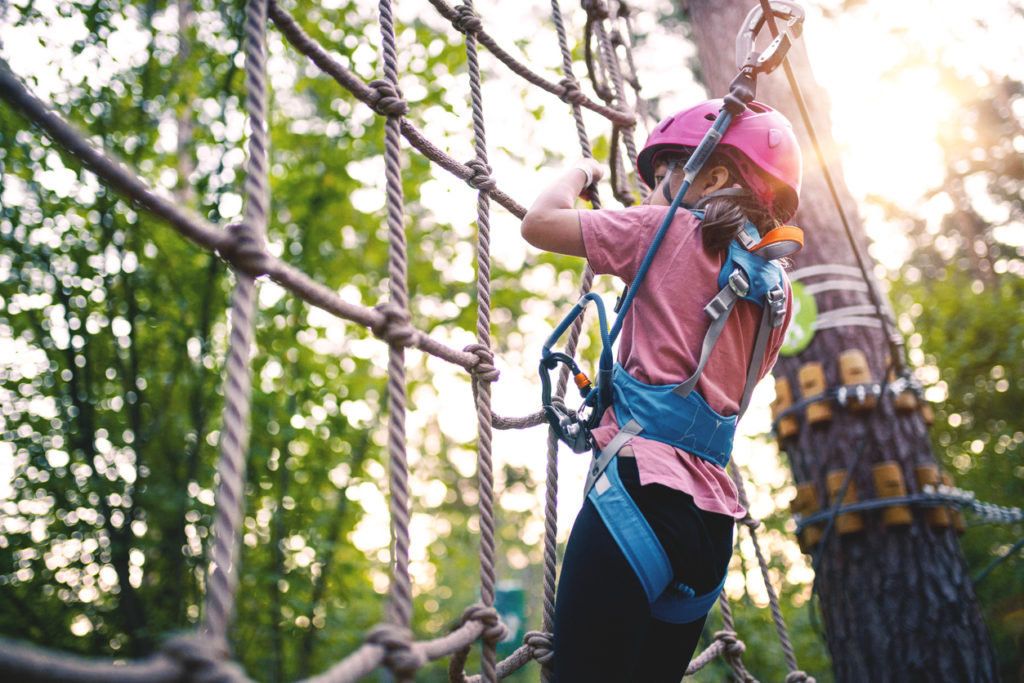 Girl overcomes obstacles in Adventure Rope Park