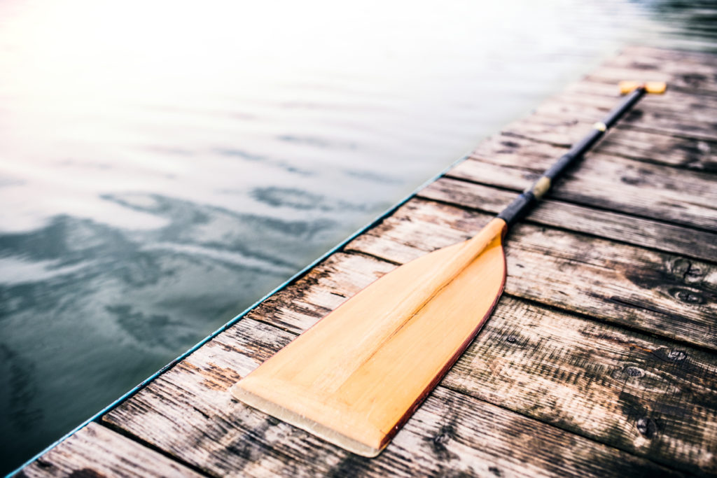 An oar on a wooden deck